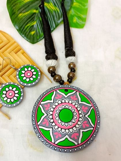 A duplicate image of the green, pink, and gray mandala pendant necklace.