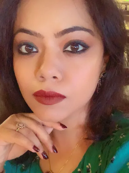 A close-up focusing on the makeup for a lunch date, with smoky eyes and a deep red lip.