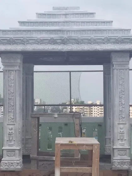 The mandir structure taking shape. This shows the scale and intricate detail of the custom-carved stone pillars and roof.