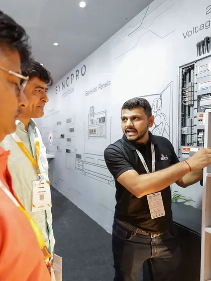 An engineer from our team explaining the technical specifications of a control panel to interested visitors at the Smart Home Expo. We are always ready to dive into the details.