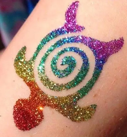 Look at the detail and color in this rainbow turtle glitter tattoo. I use multiple shades of cosmetic-grade glitter to make each design pop, ensuring it’s a standout piece of temporary body art.