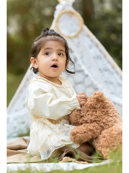A tender moment between a little girl and her teddy bear. This photo captures the gentle side of Aanshi's personality during her first birthday shoot.