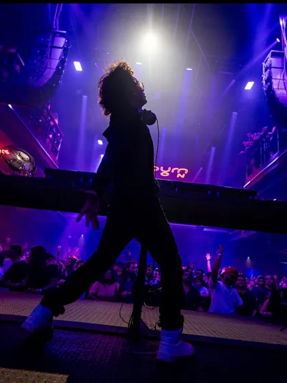 A powerful silhouette shot from a major show. This image was used for my tour announcement, capturing the energy I bring to the stage.