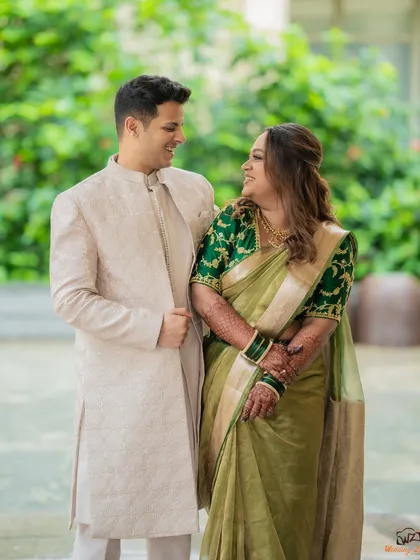 A happy, candid interaction between Shami and Udit in a garden setting. Their shared laughter makes this a warm and genuine portrait.