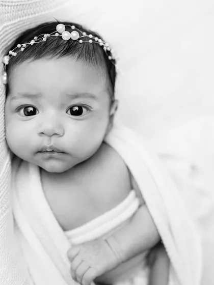 A simple and stunning black and white portrait of a newborn. Removing color helps focus on their delicate features and peaceful expression.