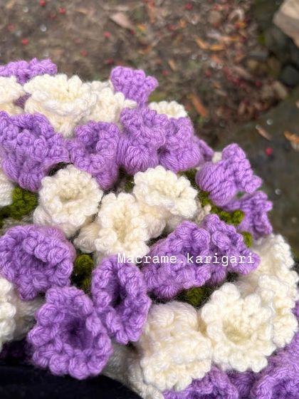 A close-up of the delicate crochet flowers that form the edge of our blanket bouquet. It's a truly unique and functional gift for a newborn.