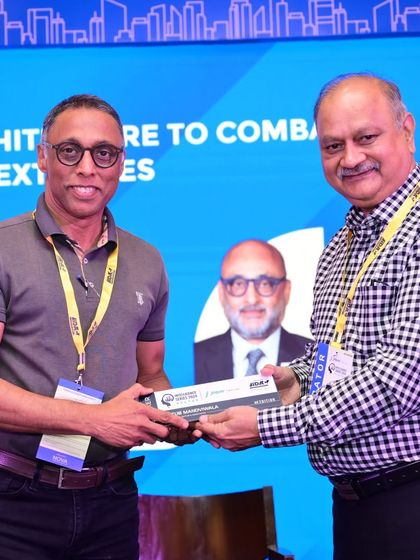 Receiving a token of appreciation at the IDAC Nagpur Intelligence Series after a panel discussion on sustainable architecture.