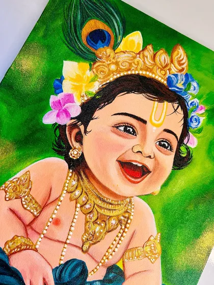 A detailed close-up of Bal Krishna's face, showing the delicate brushwork on his crown, peacock feather, and joyful expression.
