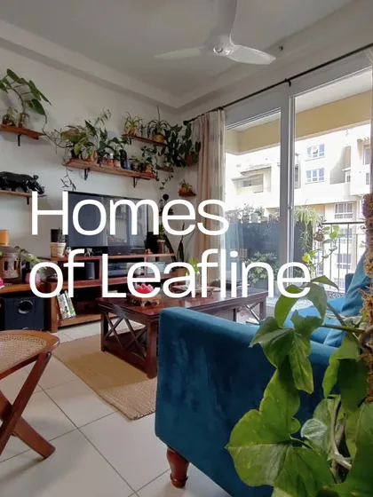 Your living space can flow seamlessly into your green space. For this home, I used a mix of floor plants, climbing pothos on a moss stick, and floating shelves to integrate nature right into the living room, creating a tranquil atmosphere that connects to the balcony garden outside.