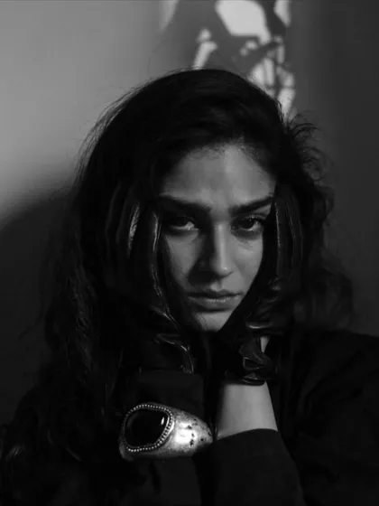 A raw and emotional black and white close-up of Kavya Trehan. The intense lighting and her direct gaze create a powerful, vulnerable portrait.