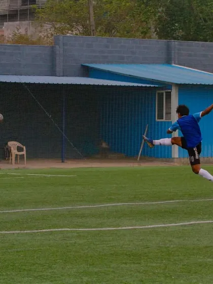 A player captured in a moment of pure power, executing a full-extension kick during a competitive match on our turf. This is the level of action our facility inspires.
