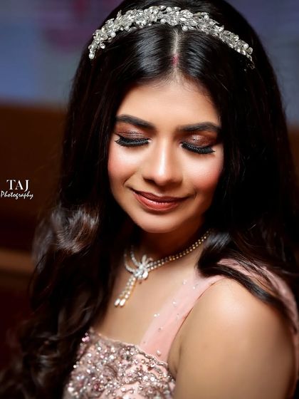 A soft and beautiful close-up of the bride. The focus on her gentle smile and sparkling tiara creates a dreamy and romantic portrait.