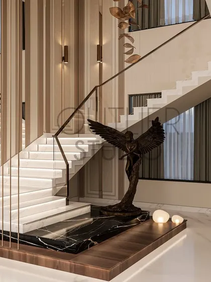 A staircase should be more than just functional; it should be a work of art. We designed this grand staircase with a sculptural winged statue and illuminated marble steps to create a dramatic and elegant experience, turning a simple passage into a design statement.