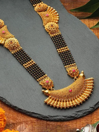 A very special billboard campaign for SJPL Sonigara. This traditional gold mangalsutra is styled on a dark slate background with marigold flowers, giving it a rustic, authentic, and culturally rich feeling.
