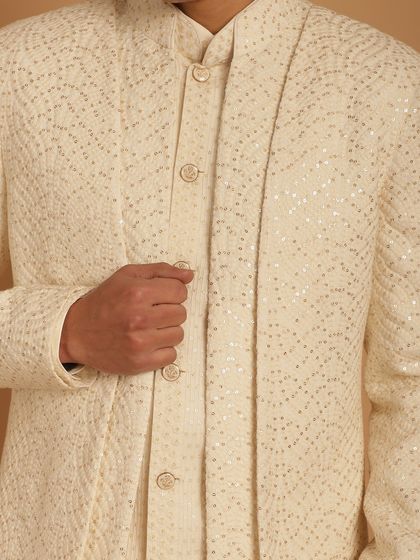 A close-up on an ivory Indo-Western jacket with sequin work, showing the subtle glamour and texture that makes our outfits special. Perfect for a Sangeet or reception.