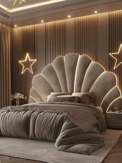 This elegant bedroom showcases a large, shell-inspired headboard against a backdrop of fluted wall panels and star-shaped neon lights for a touch of glamour.