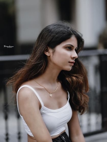 A profile shot that captures a quiet, contemplative moment. The soft lighting and natural hair styling add to the authentic feel.