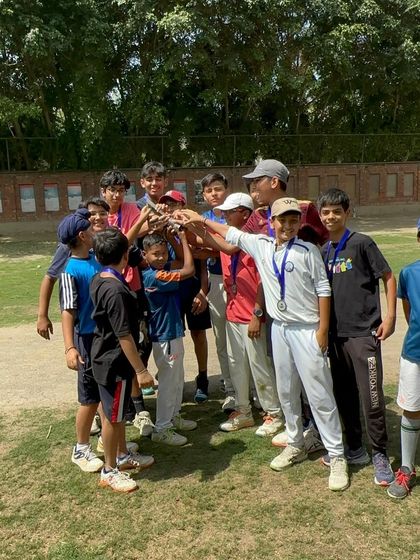 The junior team comes together to lift their hard-earned trophy. This is a memory they will cherish and a testament to their teamwork.