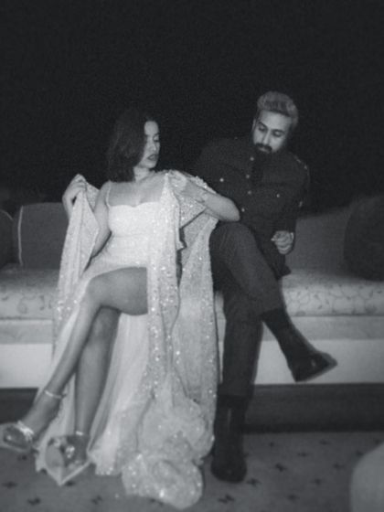 A playful and stylish black and white shot from the couple's cocktail night. This image captures their dynamic energy and modern romance, showing that wedding photography can be both fun and chic.