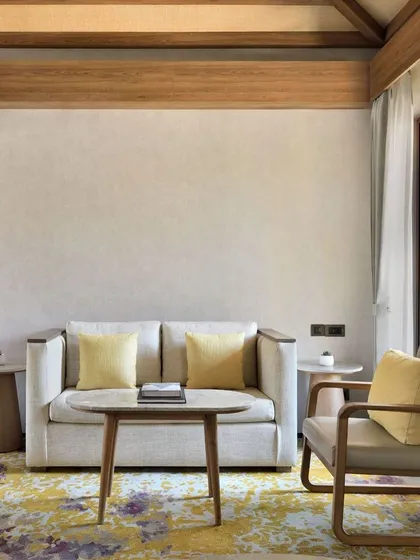 Our suites include a comfortable and stylish living area, furnished with a plush sofa and armchair. It is the perfect corner to read a book or simply relax after a day of exploring.