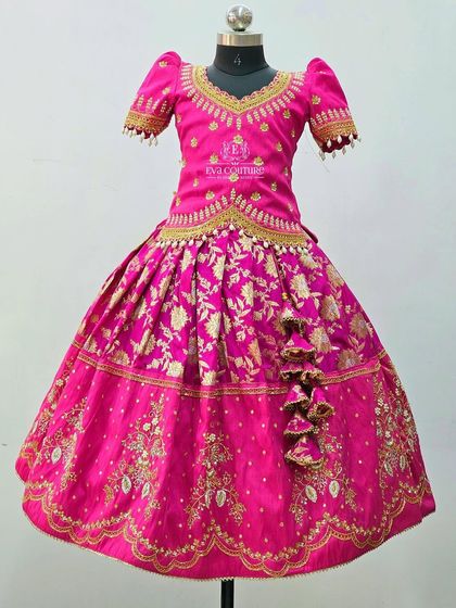 A magnificent all-pink Banarasi silk lehenga. The entire outfit is detailed with heavy maggam work for a truly special occasion.