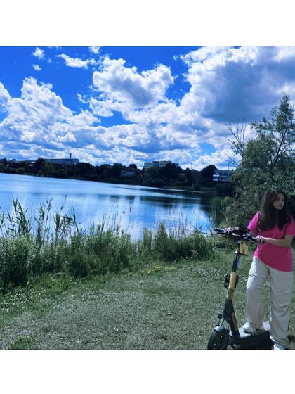A fun shot with an electric scooter by a lake, showing an active and adventurous lifestyle.