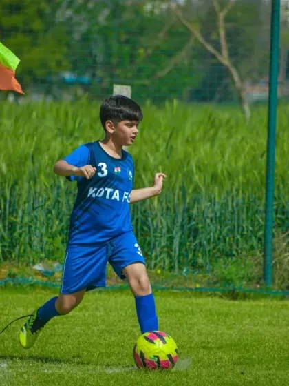 A young player gets ready to take a corner kick, a key set-piece opportunity in a competitive match.
