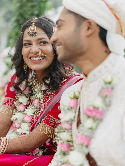 A quiet moment of connection during the ceremony. The soft smiles and eye contact between Sanket and Sakshi tell a story of love and companionship.