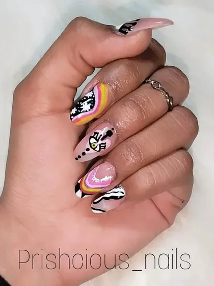 Mix and match nails for when you can't decide on just one design. This set features a rainbow, an evil eye, zebra print, and starry night art.