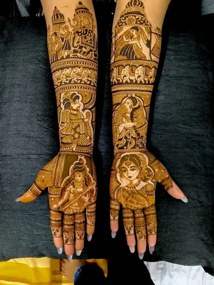 A very detailed design featuring multiple figures, including the bride, groom, and deities, telling a story of love and blessings.