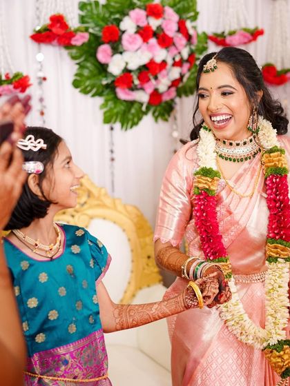 A heartwarming moment between the bride and a young family member. Her happy, glowing makeup looks beautiful even in candid shots.