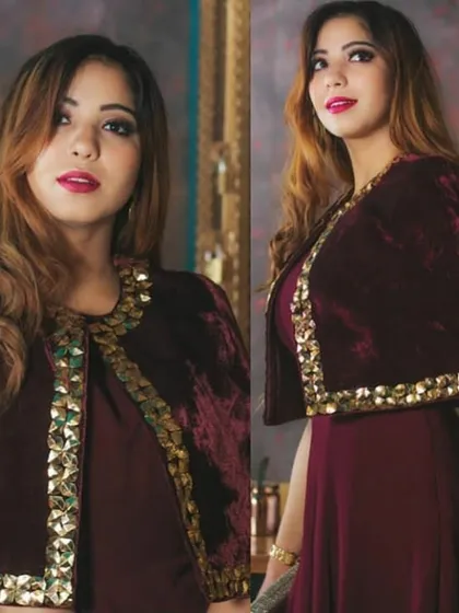 This modern Indo-Western outfit features a rich maroon velvet cape with striking gold embellishments. It's a perfect choice for a cocktail party, sangeet, or a stylish wedding guest look.