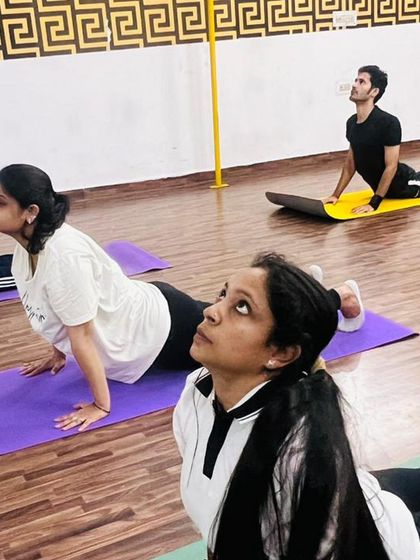 Focus and determination during our upward-facing dog sequence. Group practice helps everyone stay motivated and push their limits together.
