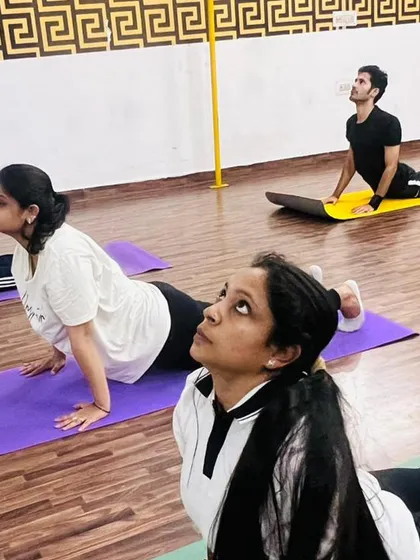 Focus and determination during our upward-facing dog sequence. Group practice helps everyone stay motivated and push their limits together.