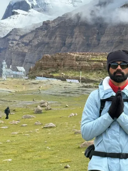 In reverence before the sacred mountain. The journey requires physical and mental fortitude, and we prepare ourselves to be worthy of the darshan we are about to receive.