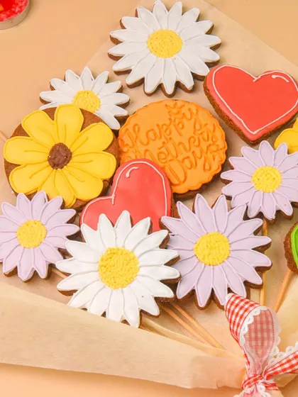 A close-up of the intricately decorated cookies in the flower-shaped cookie bouquet.