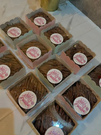 These individual brownies were made as special treats for Raksha Bandhan. Each one is drizzled with chocolate and packed in its own box with a festive sticker.