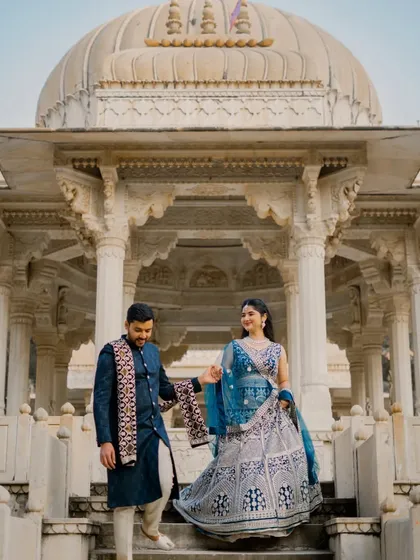 A classic romantic pose on the steps of a royal cenotaph. The leading lines of the steps and the couple's connected hands guide the eye, creating a beautifully composed pre-wedding picture.