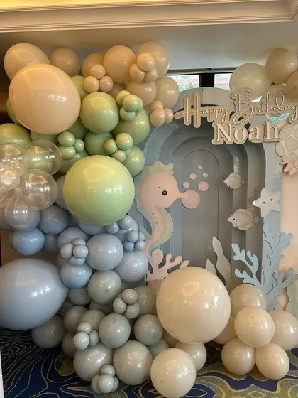 A soft and dreamy "Under the Sea" backdrop for Noah's first birthday, using a gentle pastel palette of blues and greens to create a calm and sweet ocean vibe.
