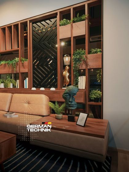 This living room, with its unique wooden partition and biophilic elements, showcases how I make luxury simple and effortlessly livable by blending premium materials with timeless design.