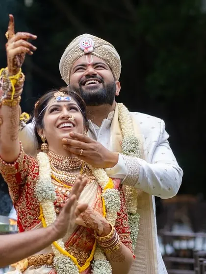 A moment of celebration and ritual, as the couple looks up joyfully during their ceremony.