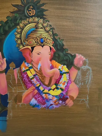 A further stage of the Ganesha painting, with more color and form added to the deity's garland and crown. This demonstrates the careful process of developing a complex spiritual artwork.