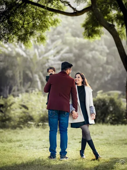 A candid shot of a family enjoying a walk in the park. This lifestyle portrait captures the natural connection and quiet moments that define a family's bond.