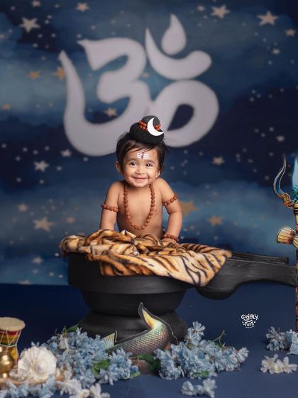 A happy little Shiva, ready to celebrate the festival with a big smile and a backdrop of the sacred Om.