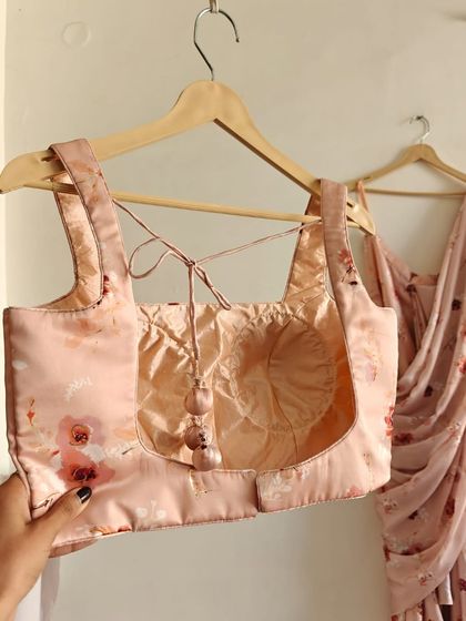 The back of the floral blouse, showing the tie-up detail with cute tassels.