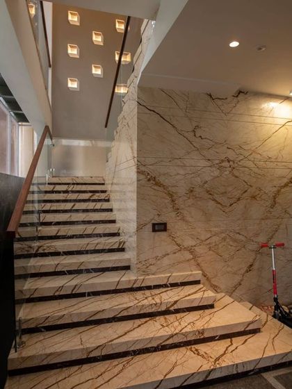 A collage of our 'Marble Love' project, highlighting key features like the floating staircase, the indoor pool with a decorative screen, and the dramatic lighting fixtures that accentuate the stone surfaces.