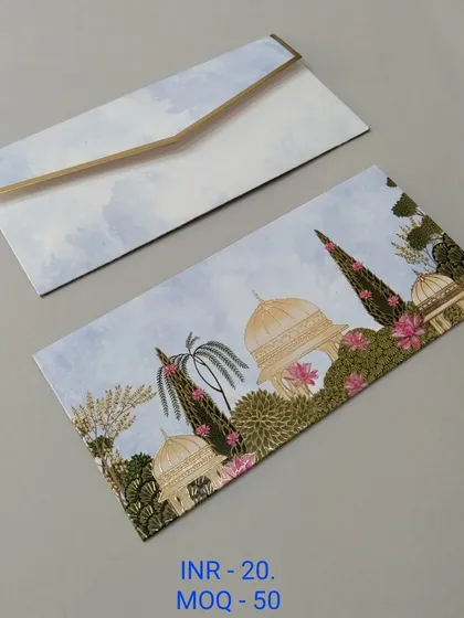 A soft pink envelope with faint silhouettes of palace domes and hanging temple bells in gold foil. This design is perfect for those who want a traditional yet understated look.