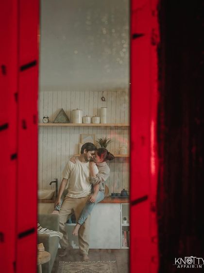 A view through a red doorway, creating a vibrant frame around this intimate kitchen scene. I love using elements of the environment to add creative layers to my photos.