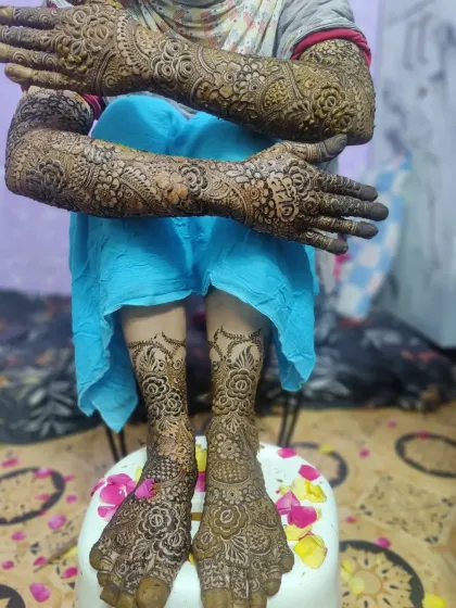 The complete bridal look, with detailed mehndi from fingertips to elbows and covering the feet. I love creating a design that flows beautifully for the entire wedding ceremony.
