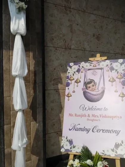 The welcome sign and entrance draping for a Naming Ceremony. The simple white fabric draping creates an elegant and clean look for the entryway.
